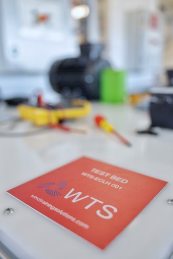 A table with an isolation checklist, a WTS pen, and an electrical cabinet key for electrical work.