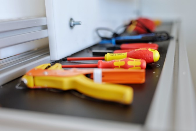 A set of hand tools used for electrical work.